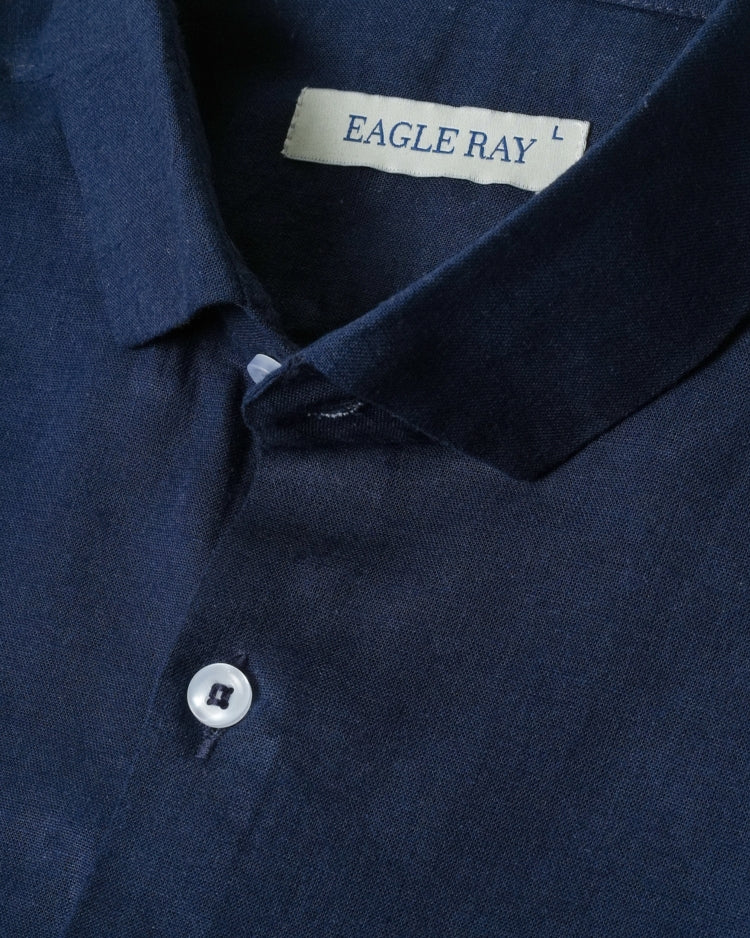 Close-up of a navy blue shirt with an 'Eagle Ray' label on the collar.