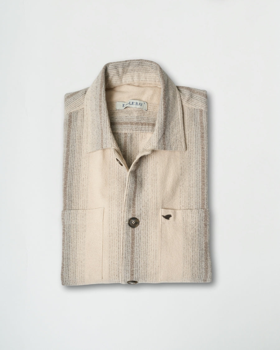 Folded shirt with a subtle pattern on a light gray background