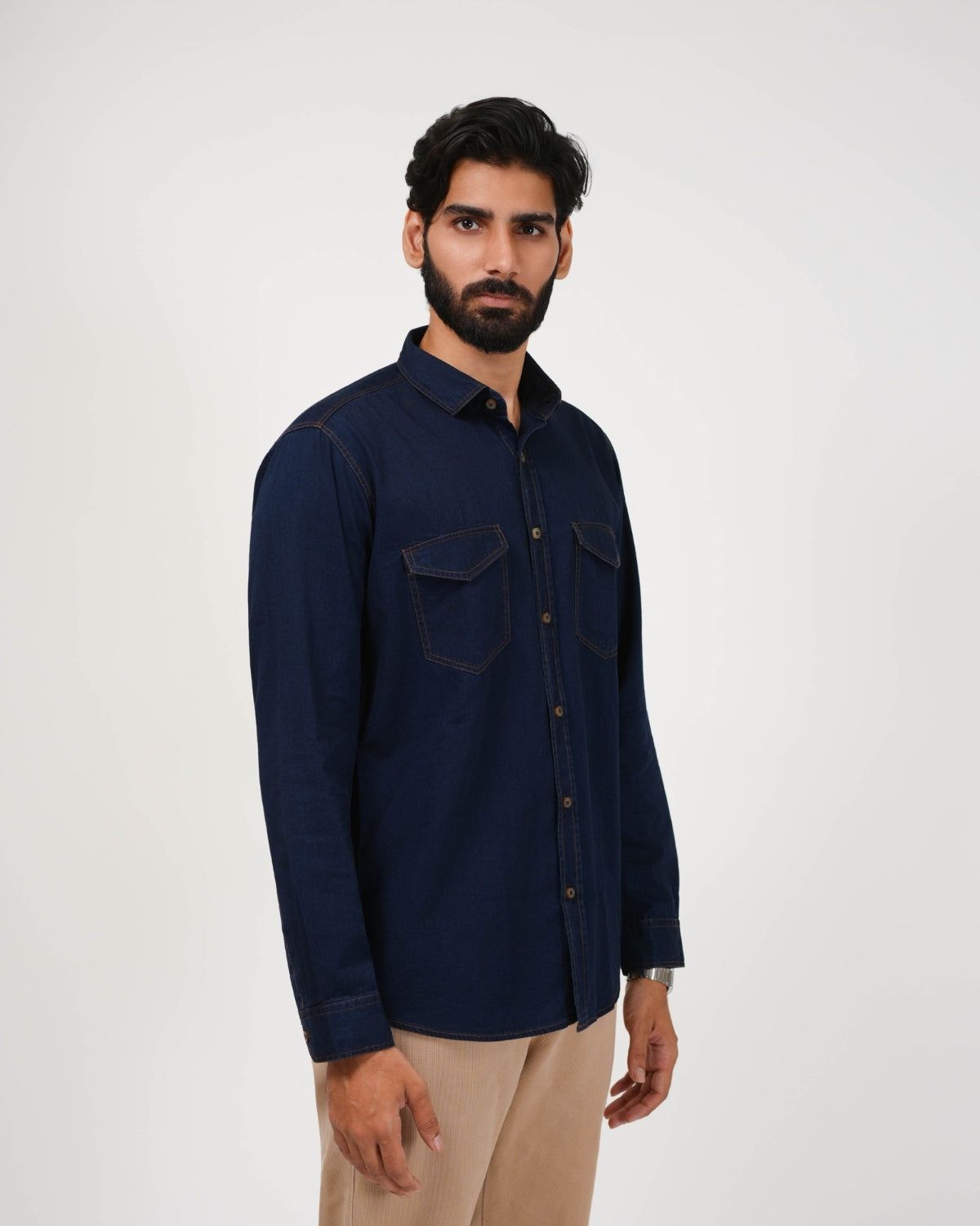 Man wearing a navy blue shirt on a white background
