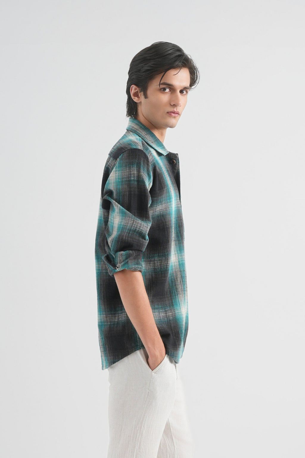 Person wearing a plaid shirt on a white background