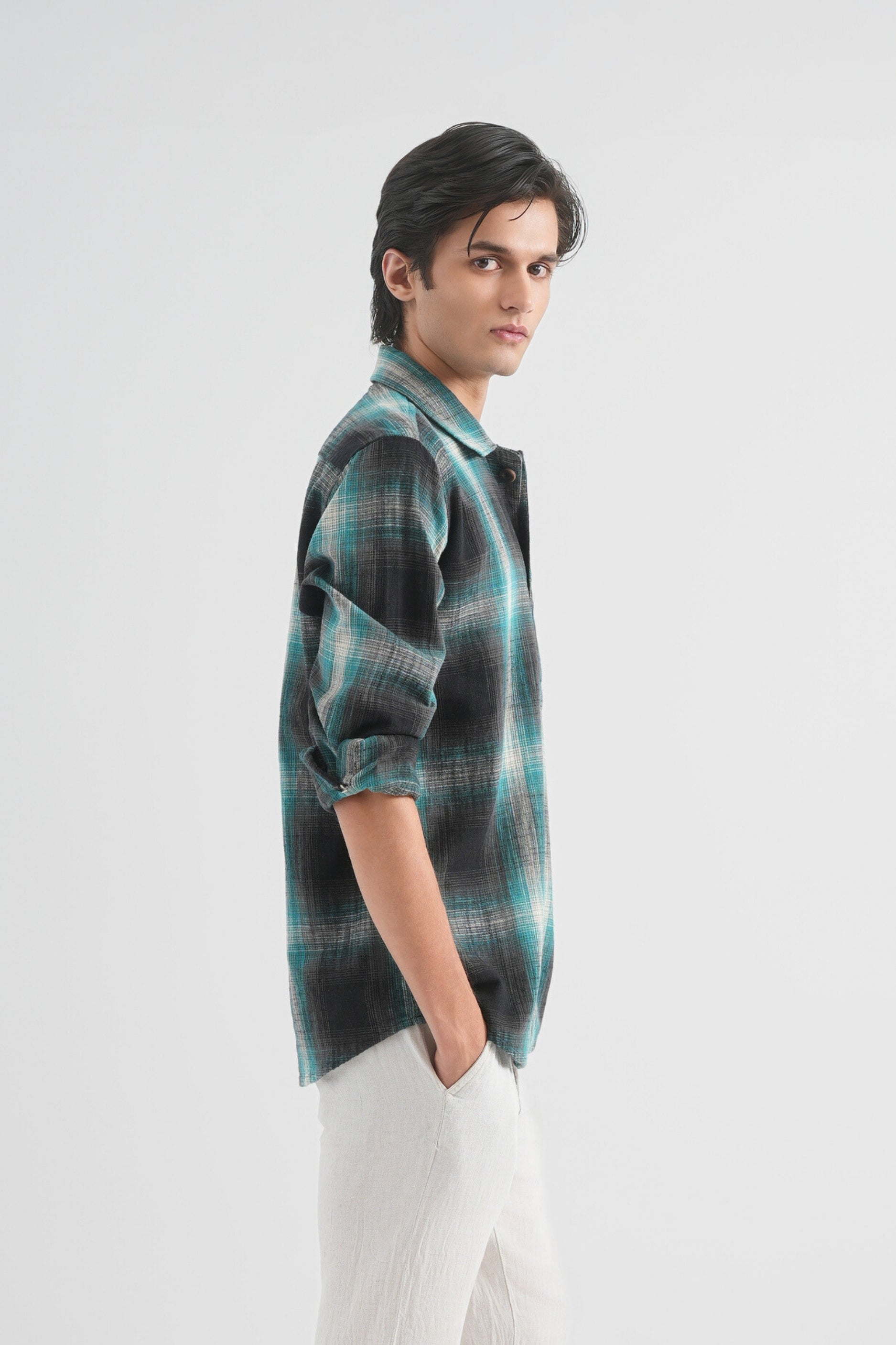 Person wearing a plaid shirt on a white background