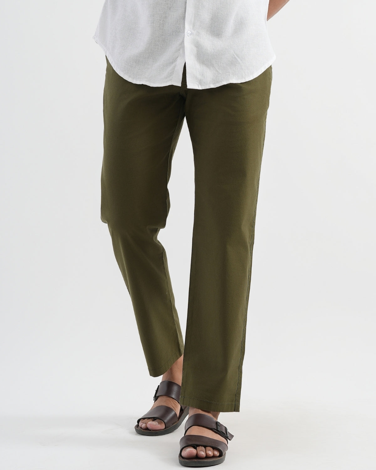 Person wearing olive green pants and a white shirt on a white background