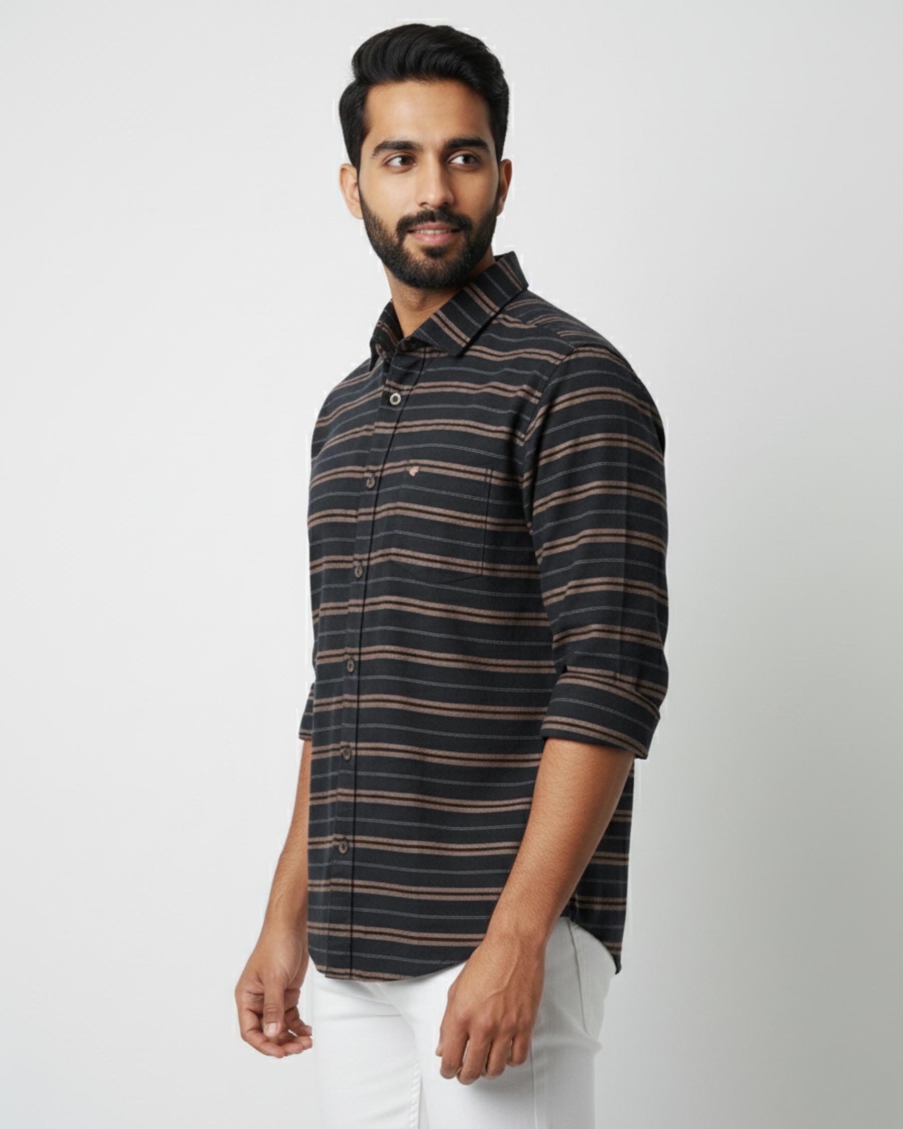 Man wearing a striped shirt against a plain background