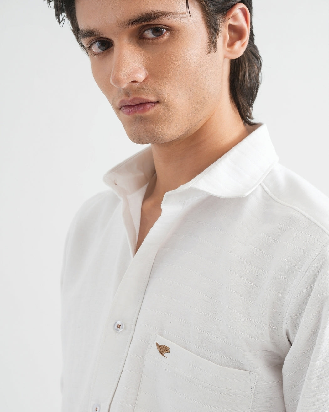 Man wearing a light gray shirt on a white background