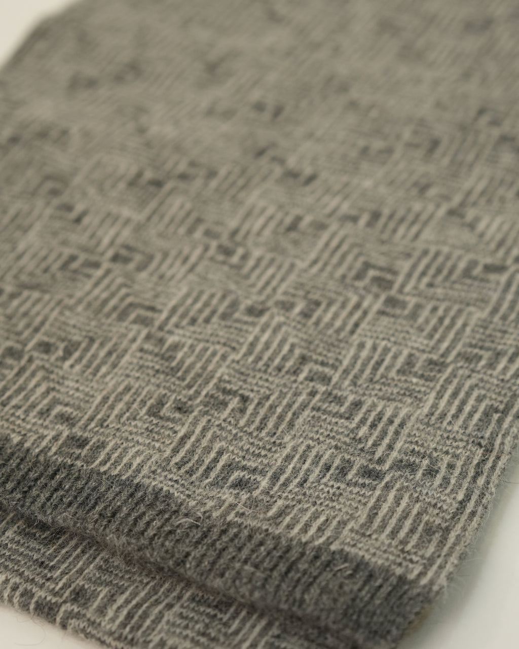Close-up of a folded gray textured fabric on a white background