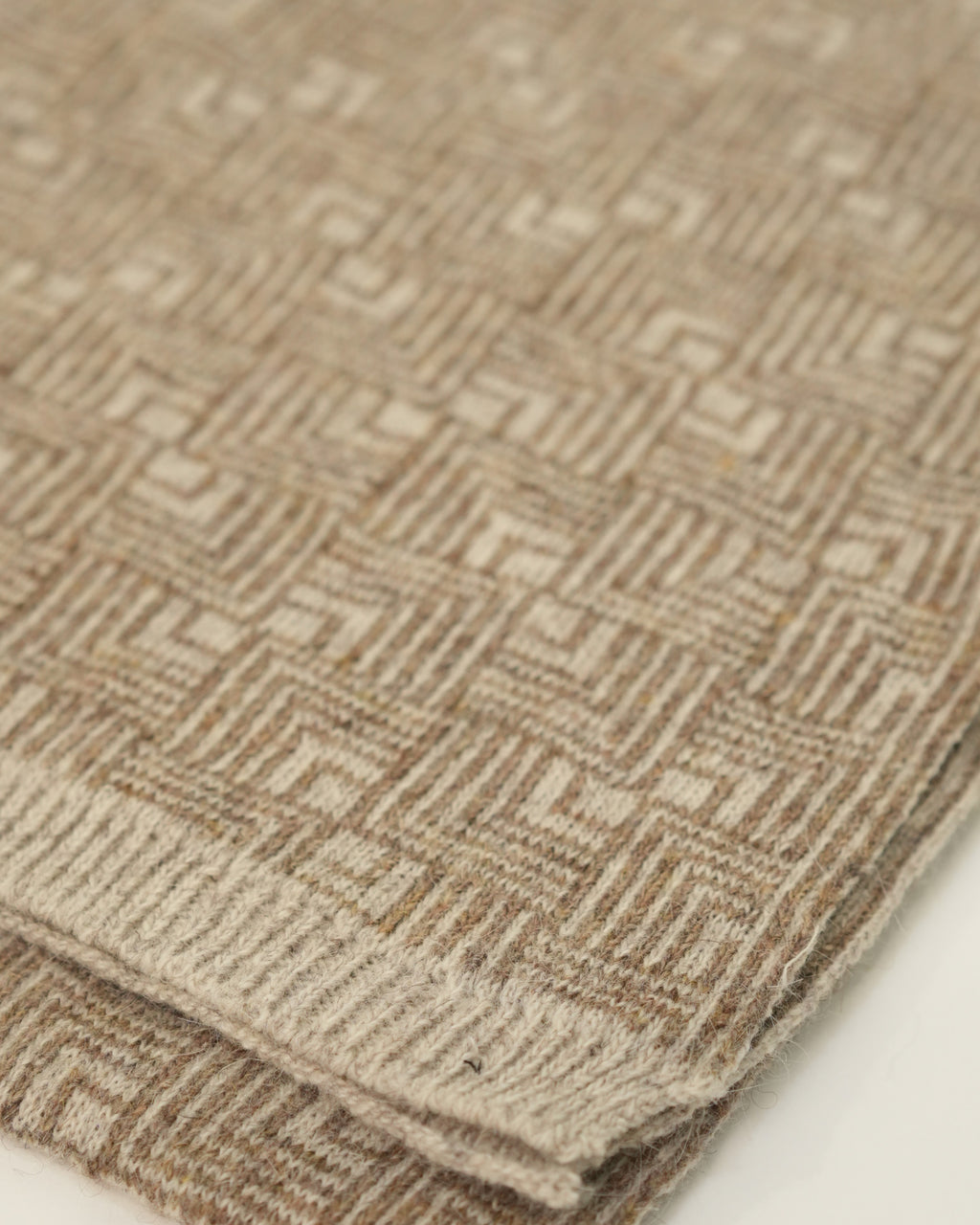 Close-up of a textured brown fabric with geometric pattern