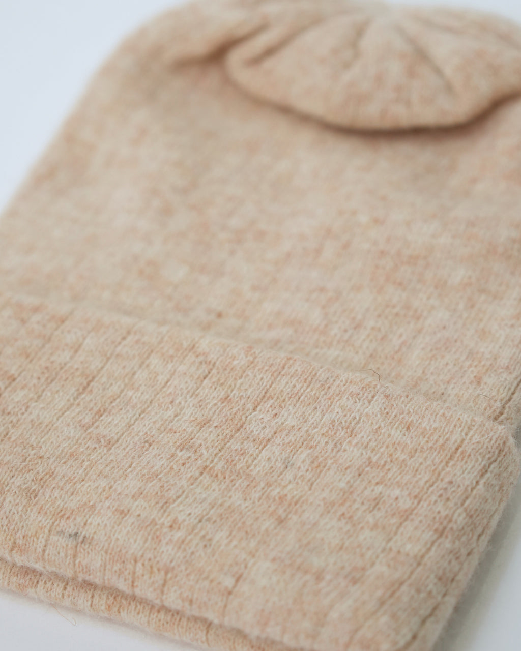 Close-up of a beige fabric texture on a white background