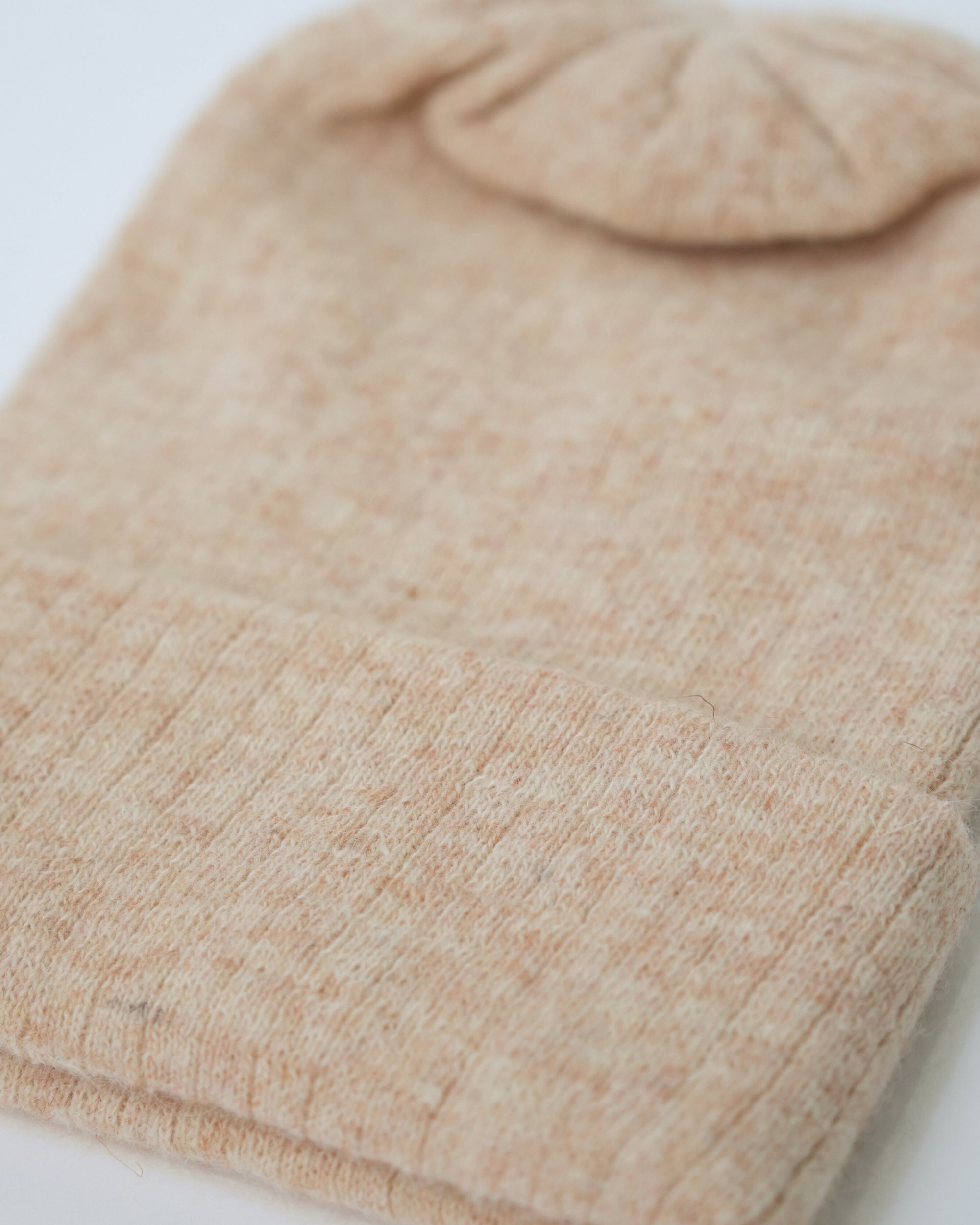 Close-up of a beige fabric texture on a white background