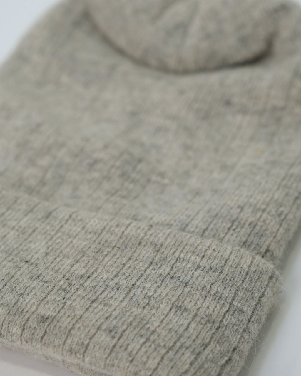 Close-up of a gray knit sweater on a white background