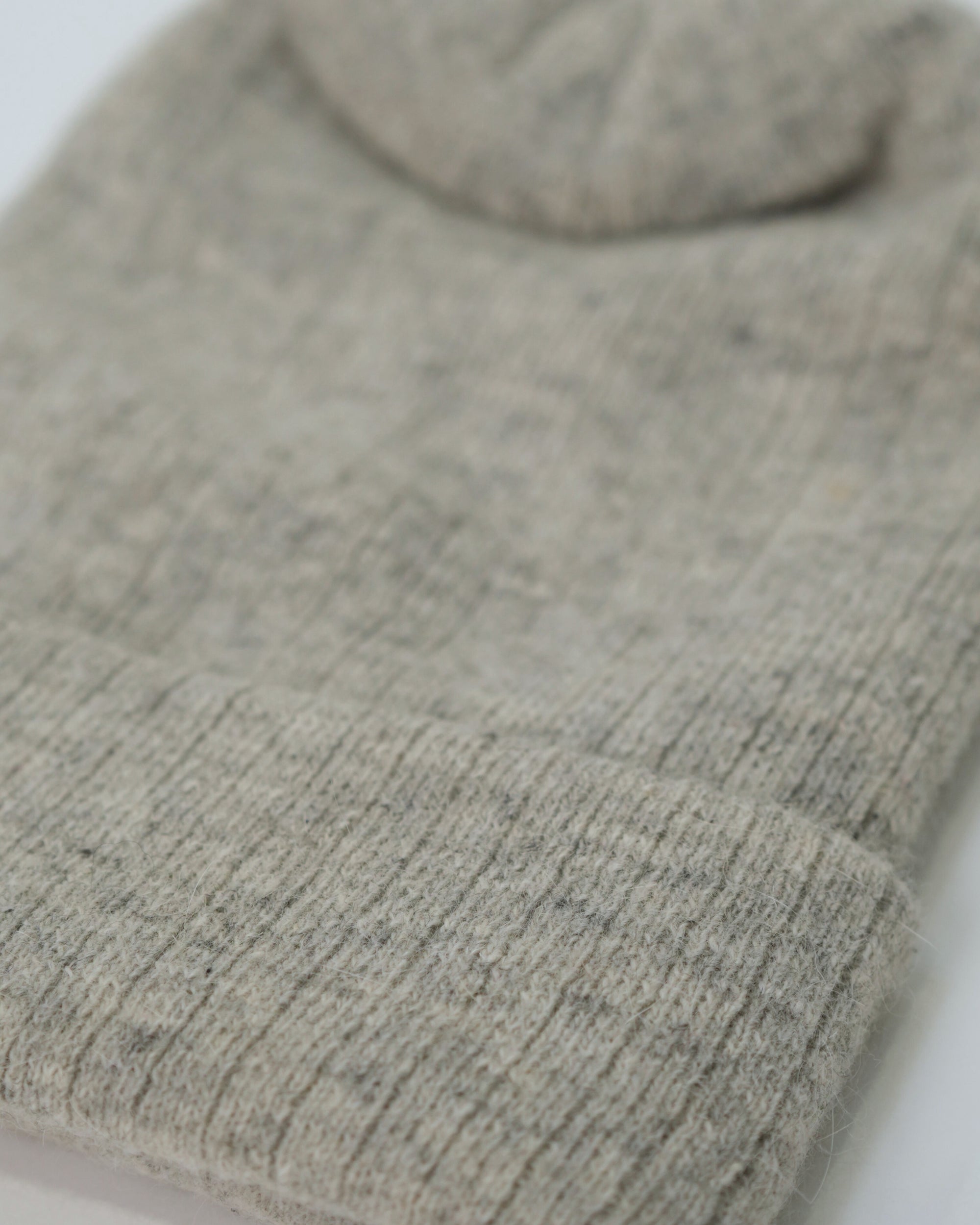 Close-up of a gray knit sweater on a white background
