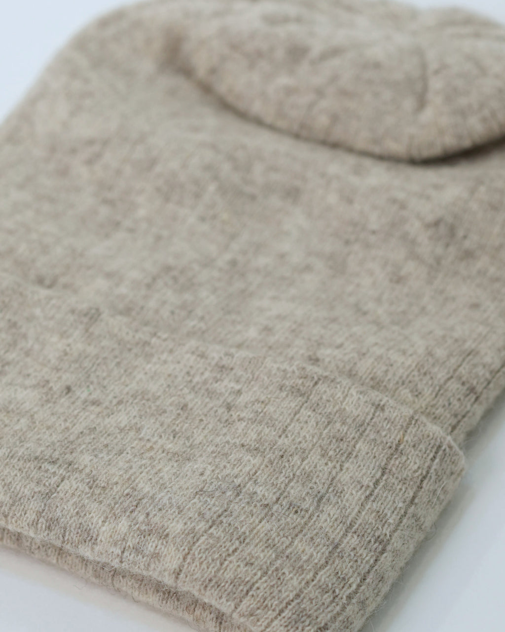 Close-up of a beige knitted fabric on a light background