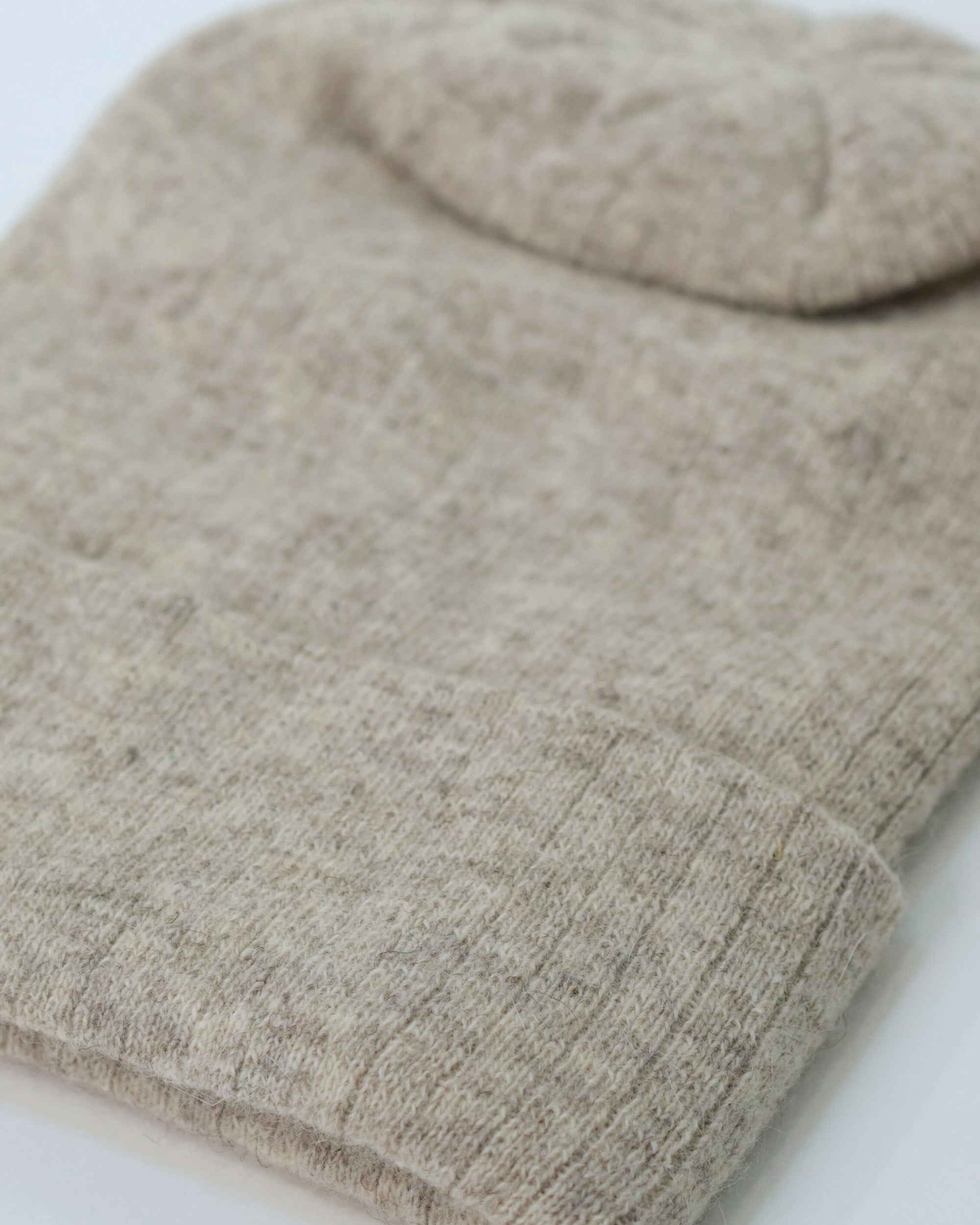Close-up of a beige knitted fabric on a light background