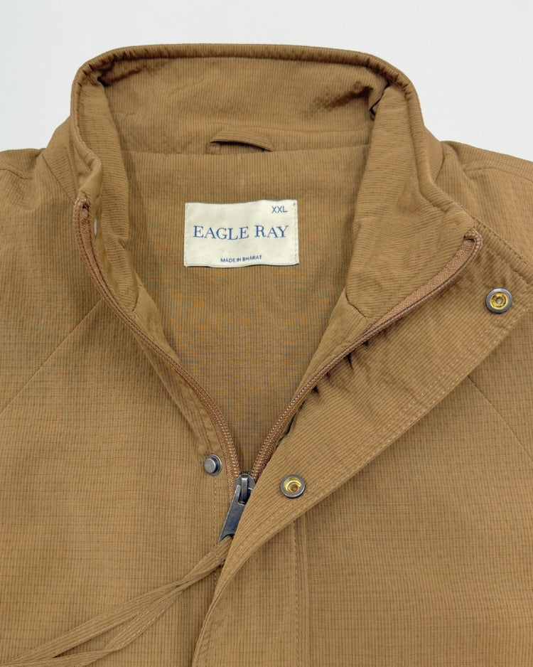 Close-up of a brown jacket with 'Eagle Ray' label on a white background