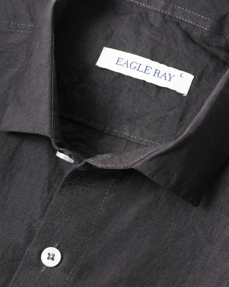Close-up of a black shirt with 'Eagle Ray' label on collar