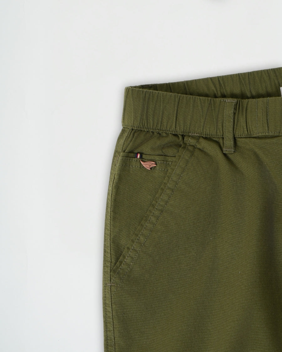 Close-up of green pants with a white background