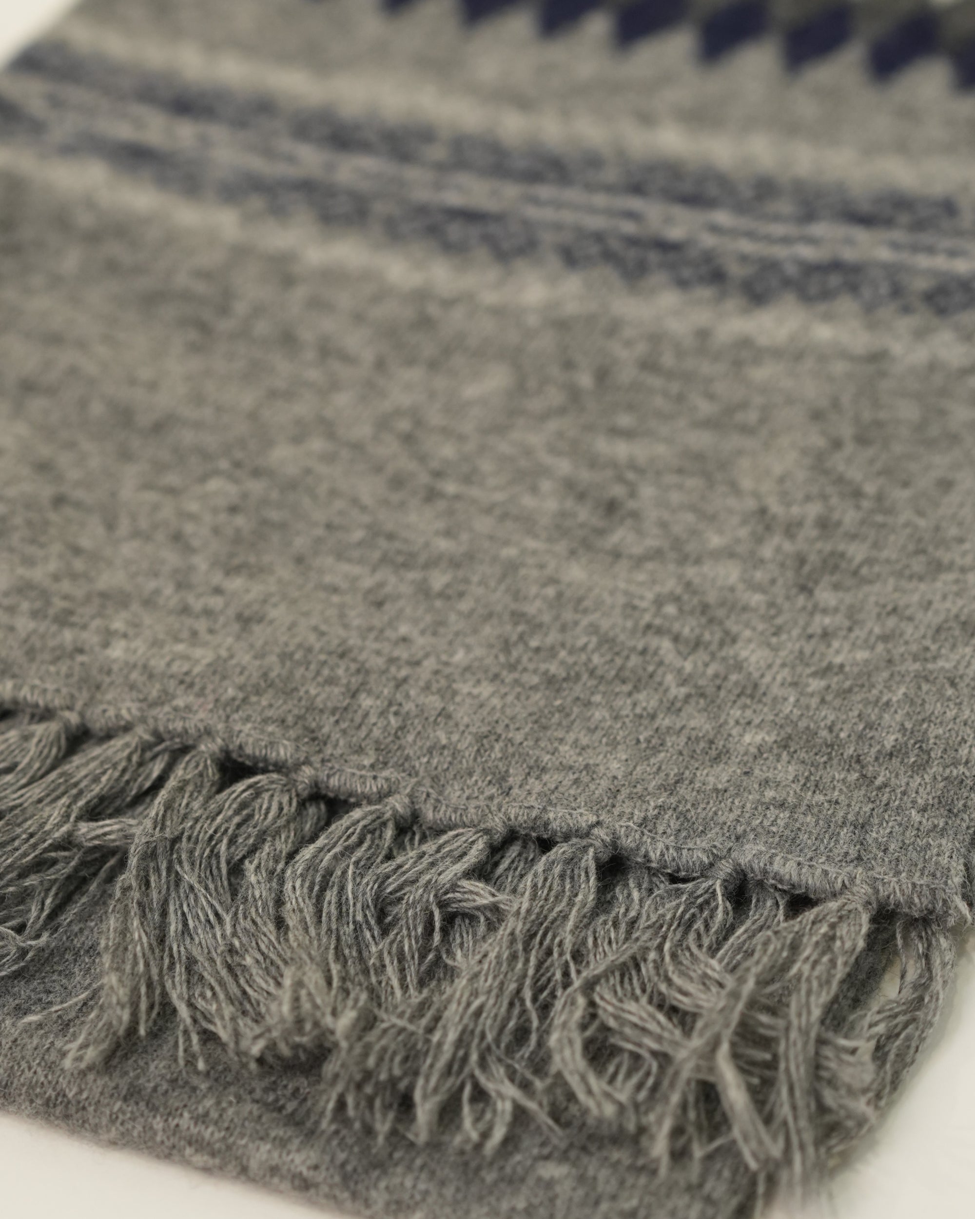 Gray textured fabric with frayed edge on a white background