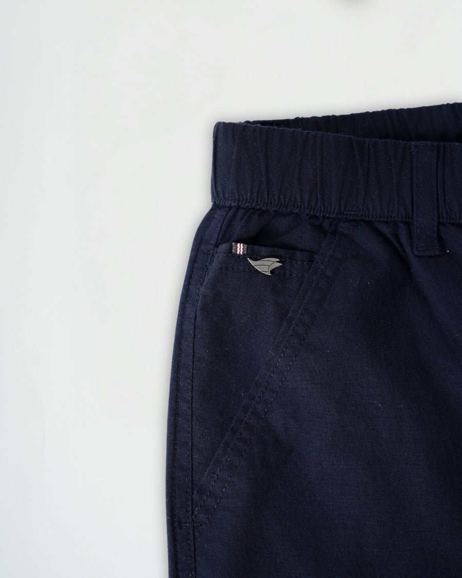 Navy blue pants with a brand logo on a white background