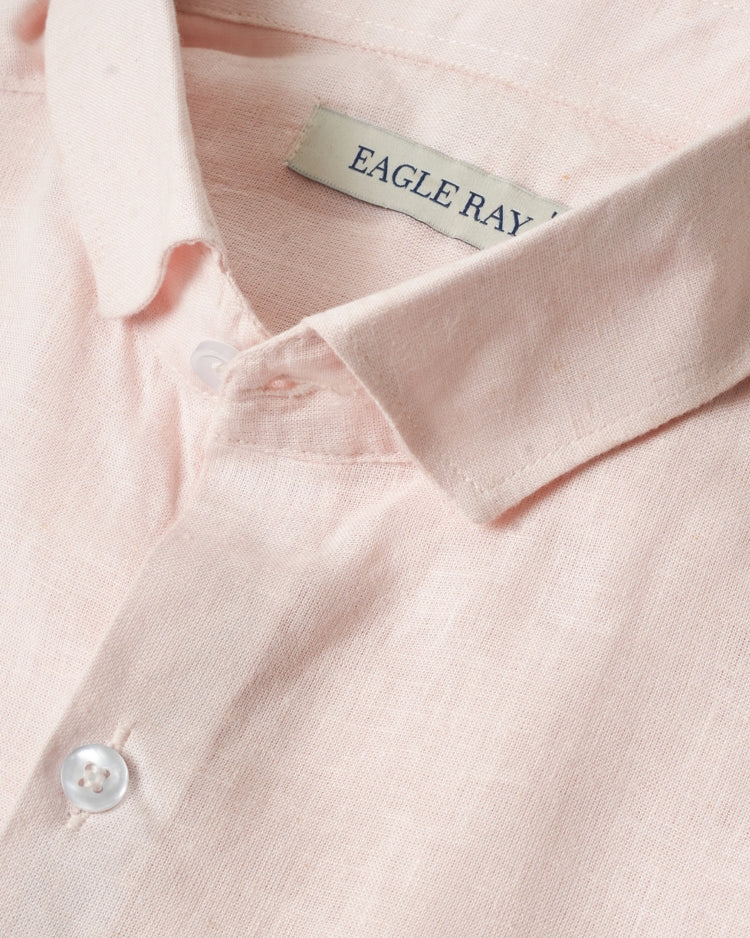 Close-up of a light pink shirt with a visible Eagle Ray label.