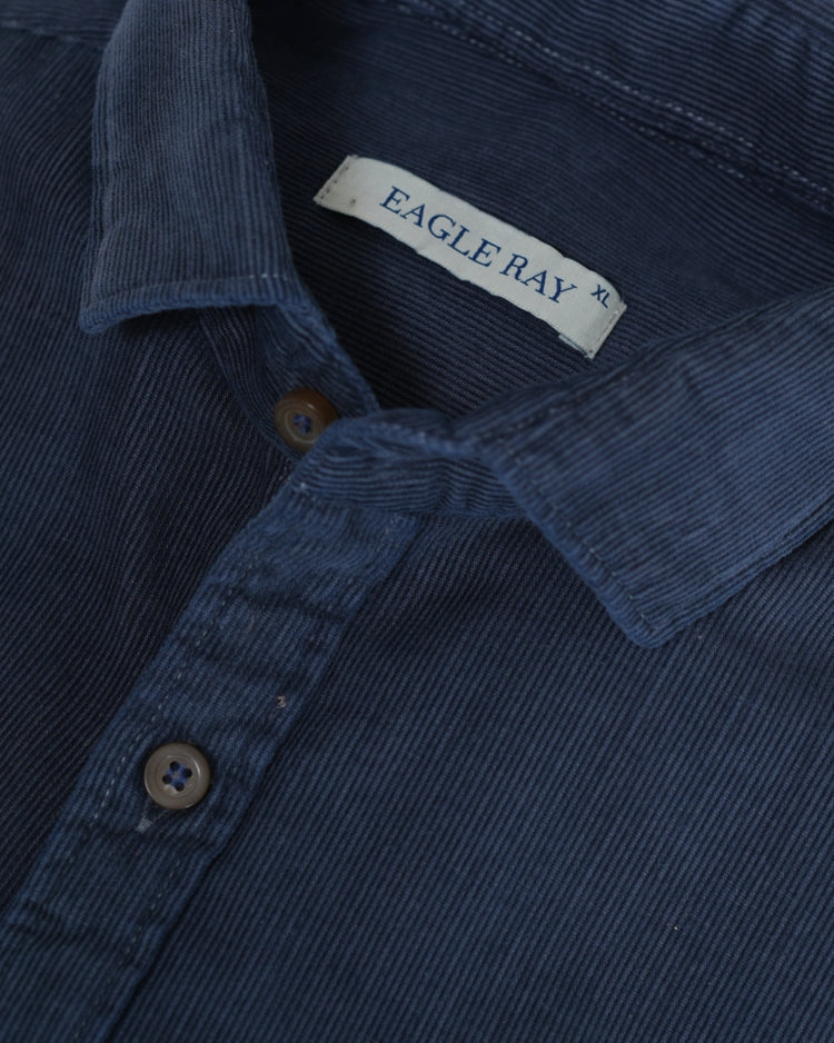 Close-up of a blue corduroy shirt with an Eagle Ray label.