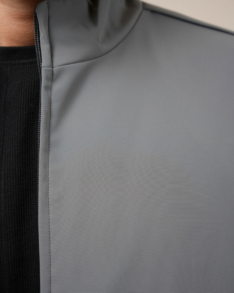 Close-up of a gray textured fabric with a black section on the side.
