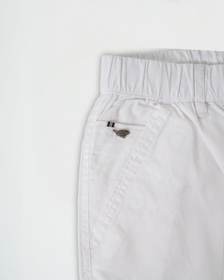 White pants with a small logo on a light gray background