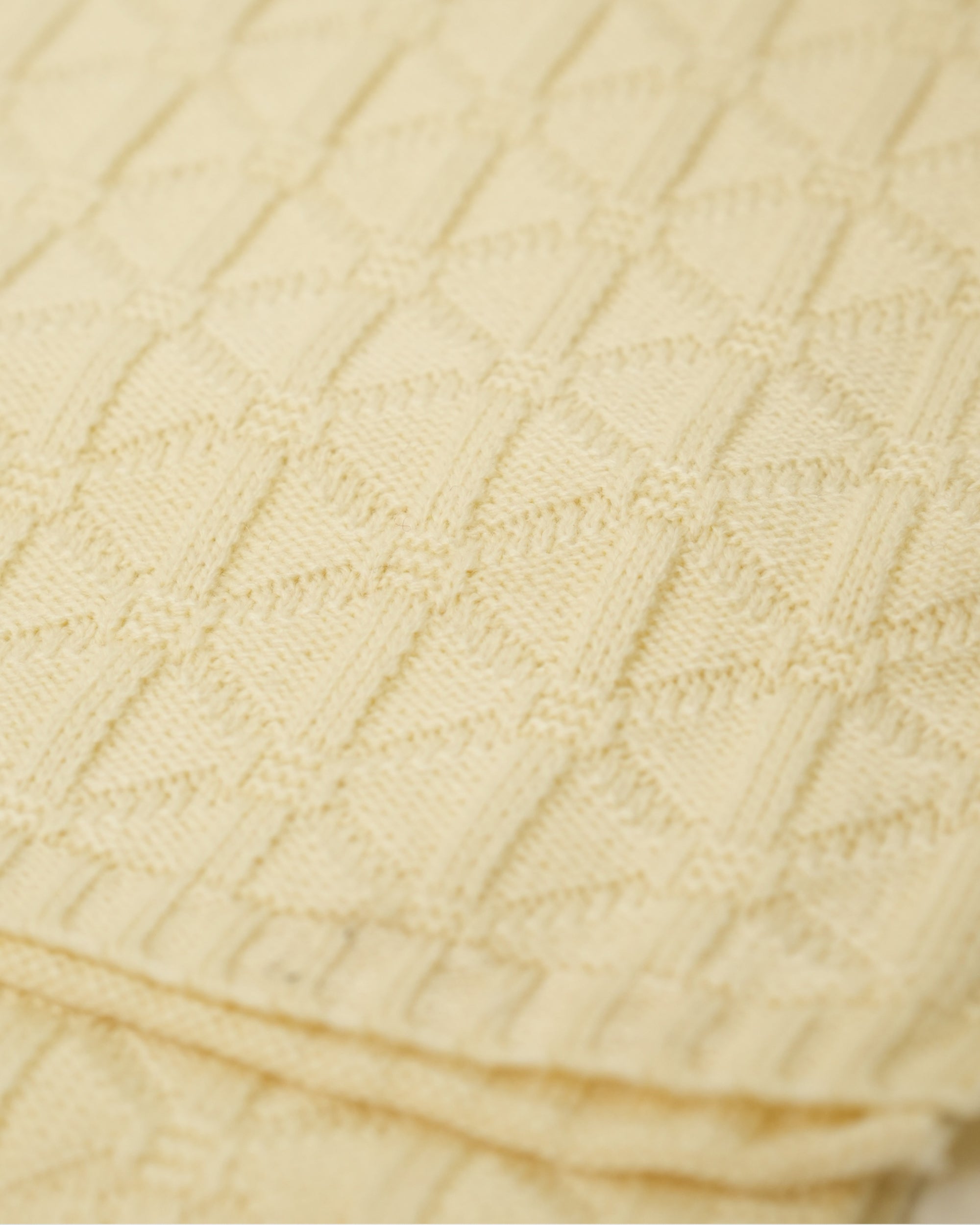 Close-up of beige textured fabric with a subtle pattern