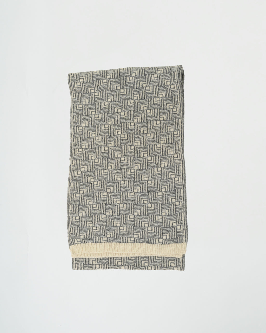 Gray patterned towel with a white border on a light gray background