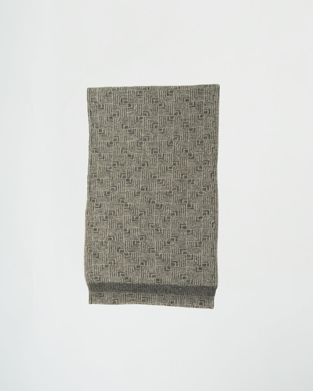 Folded fabric with a geometric pattern on a white background