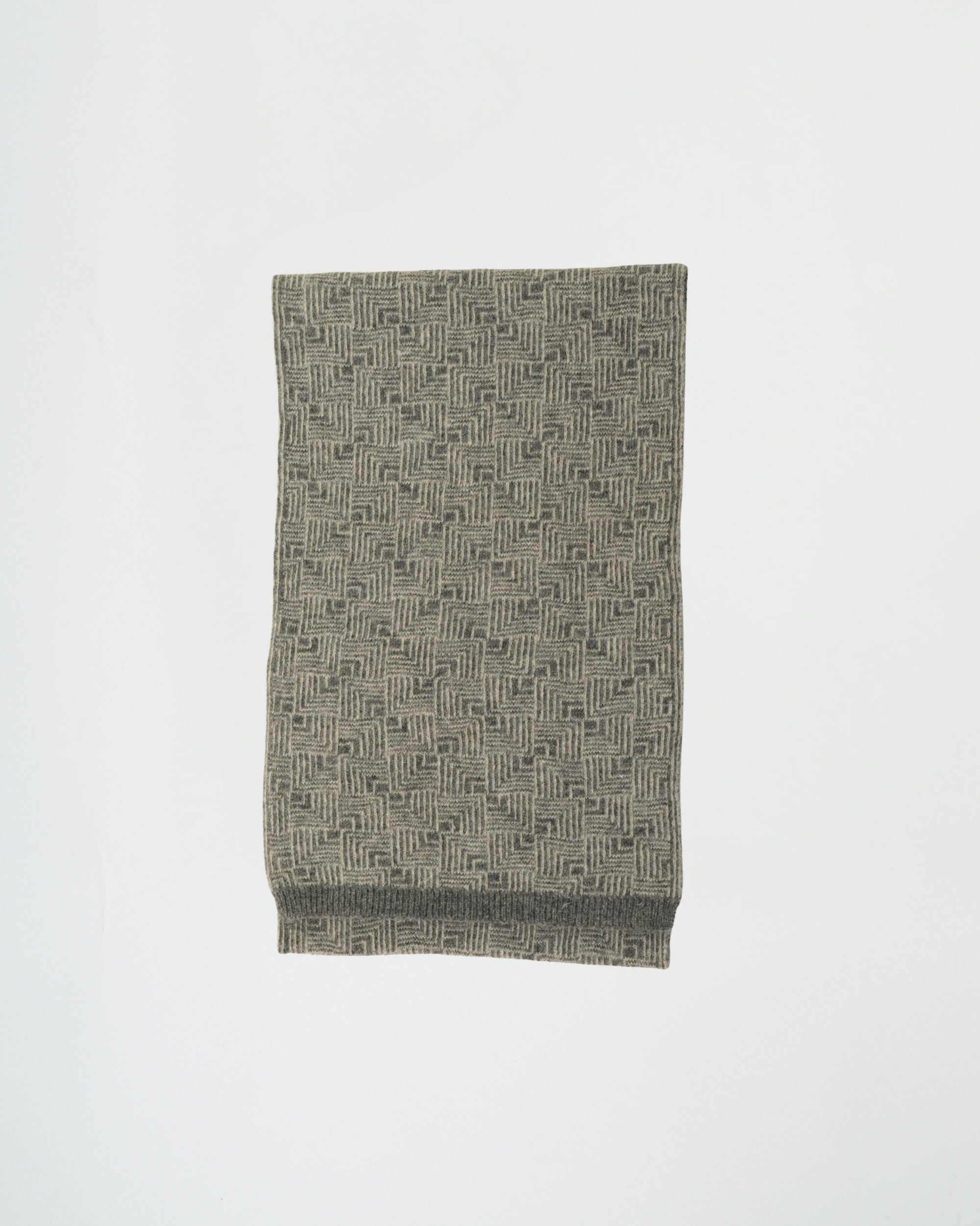 Folded fabric with a geometric pattern on a white background