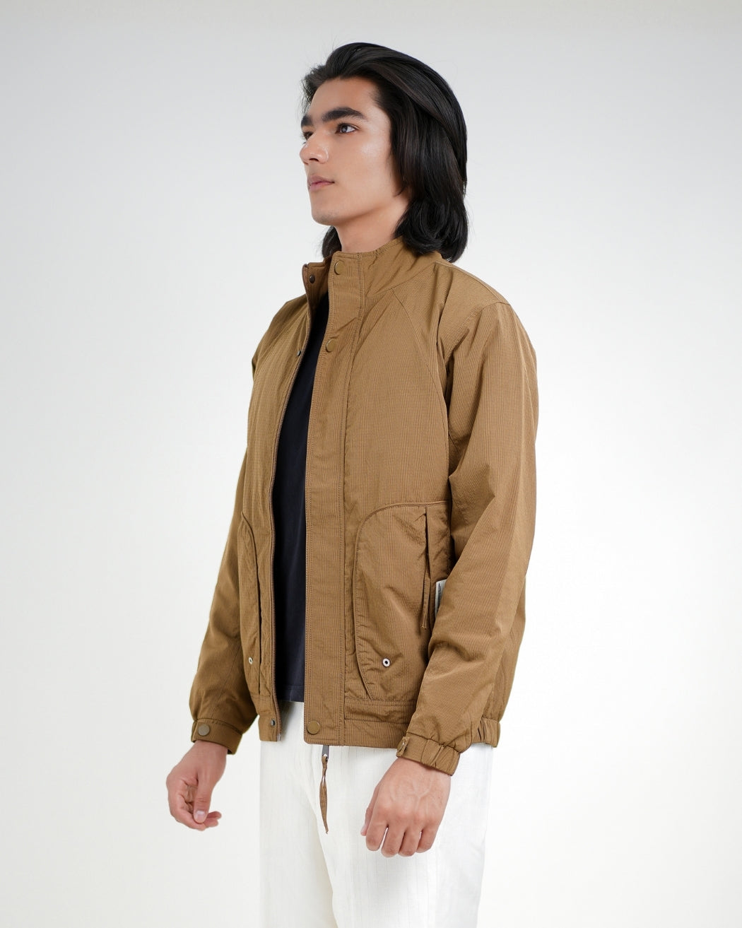 Man wearing a brown jacket on a white background
