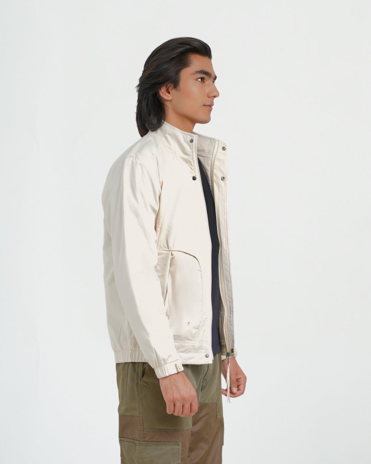 Man wearing a beige jacket on a white background