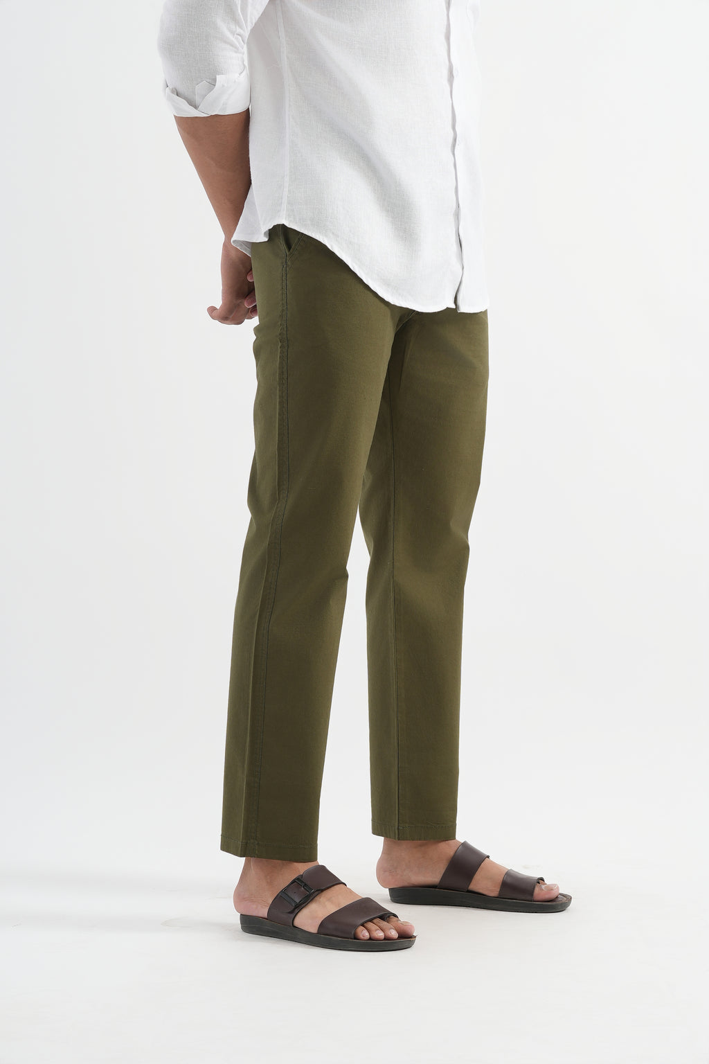 Person wearing a white shirt and green pants on a white background
