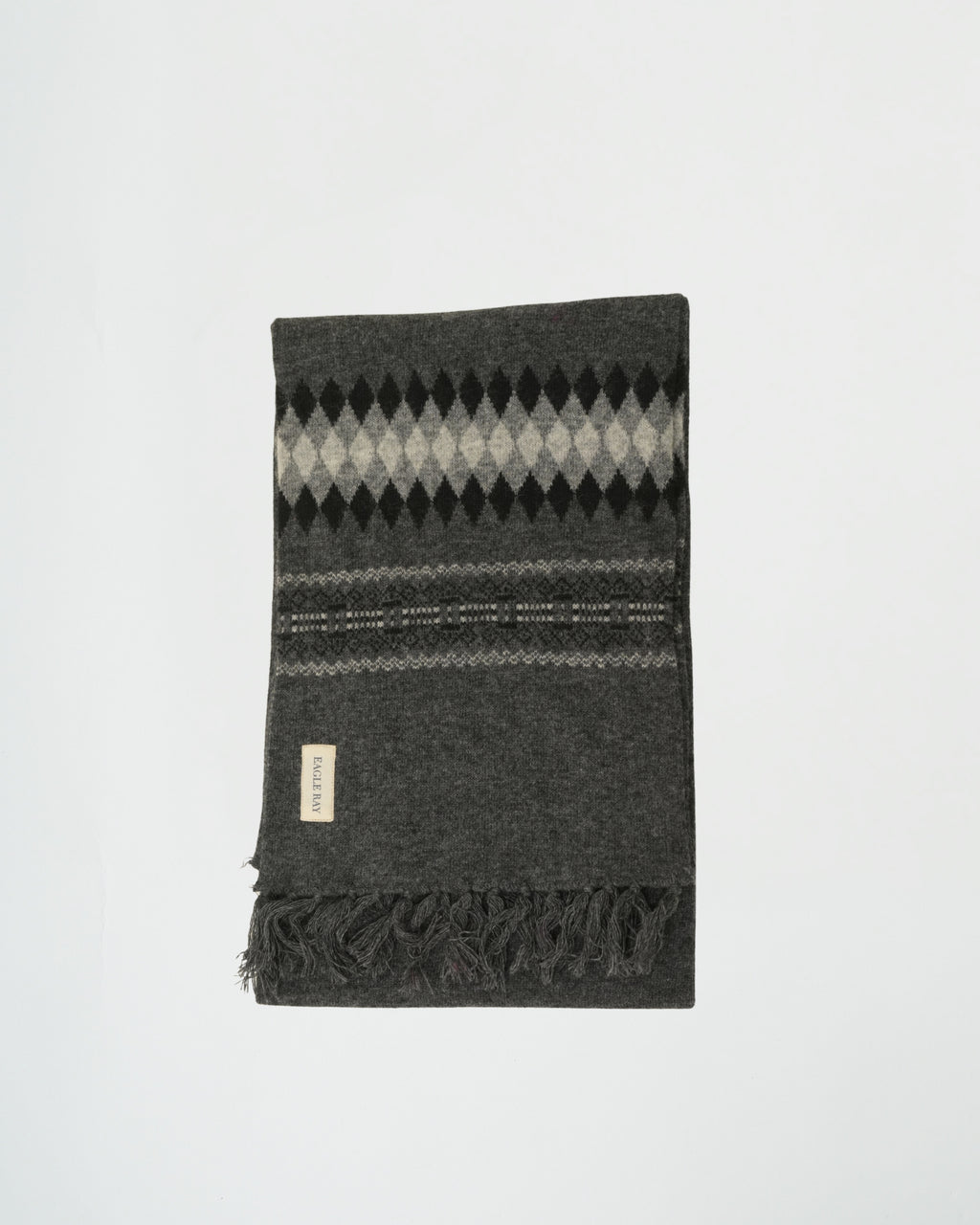 Gray argyle patterned blanket with fringes on a white background