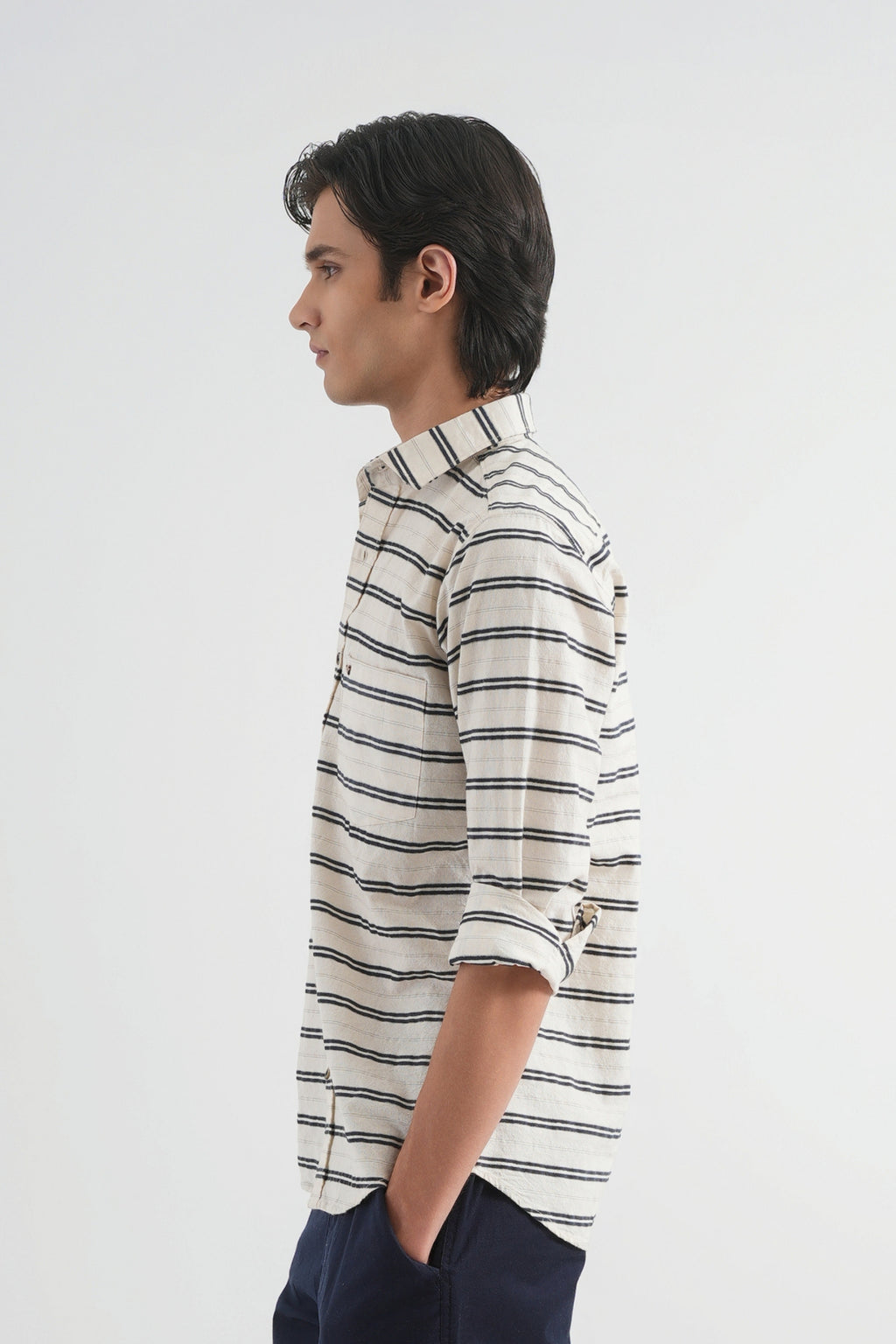 Man wearing a striped shirt against a plain background