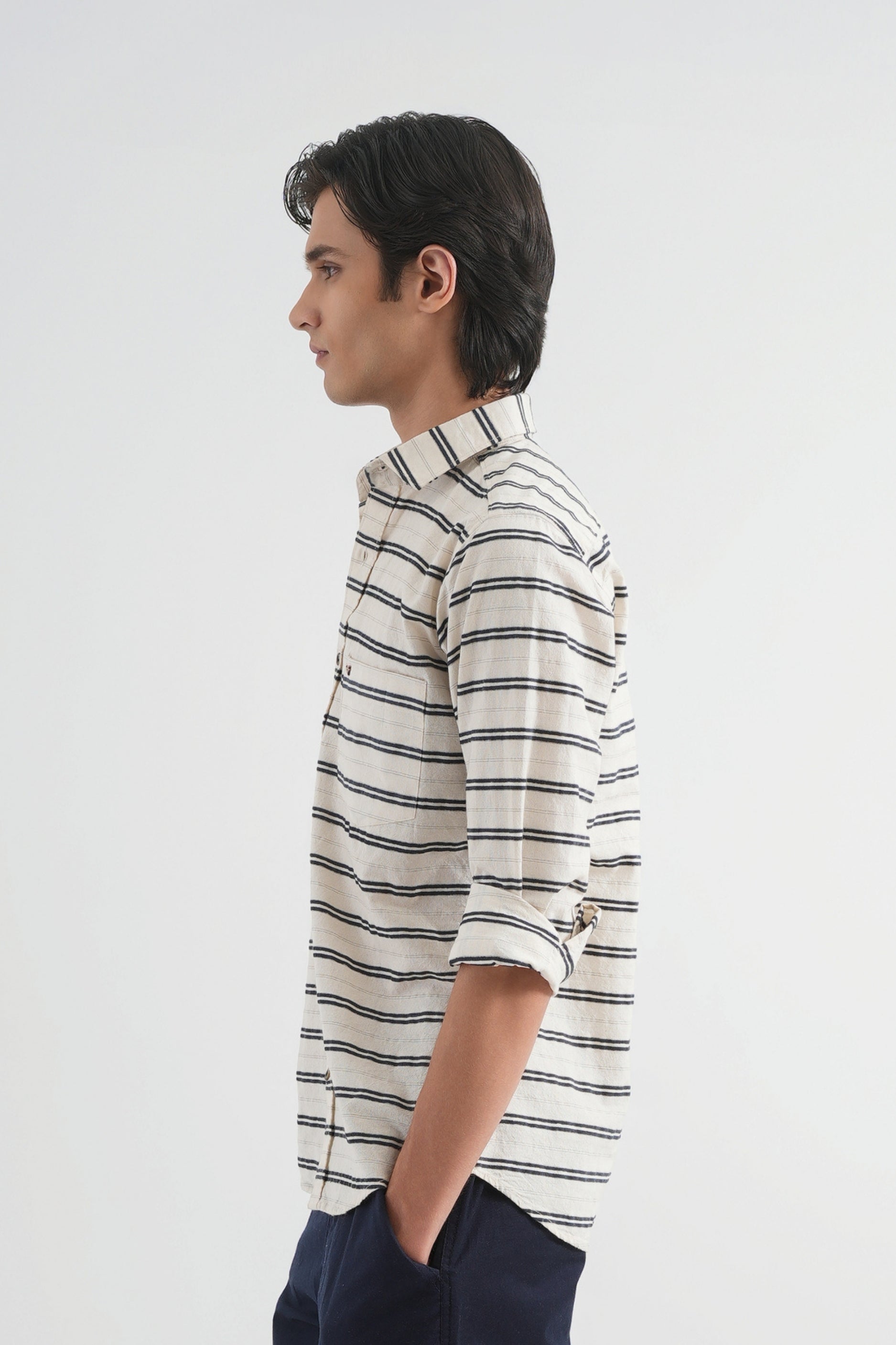 Man wearing a striped shirt against a plain background