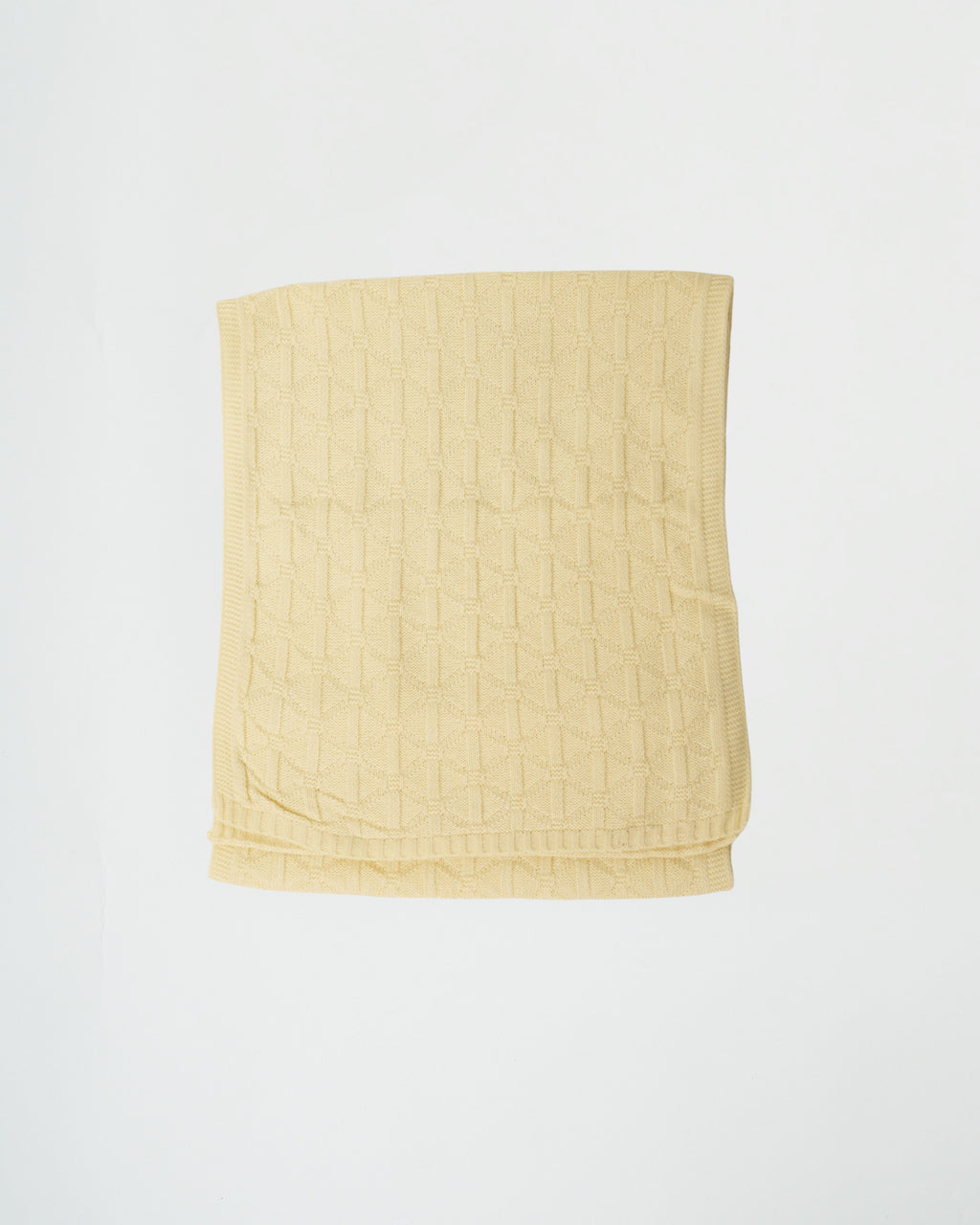 Yellow quilted blanket on a white background