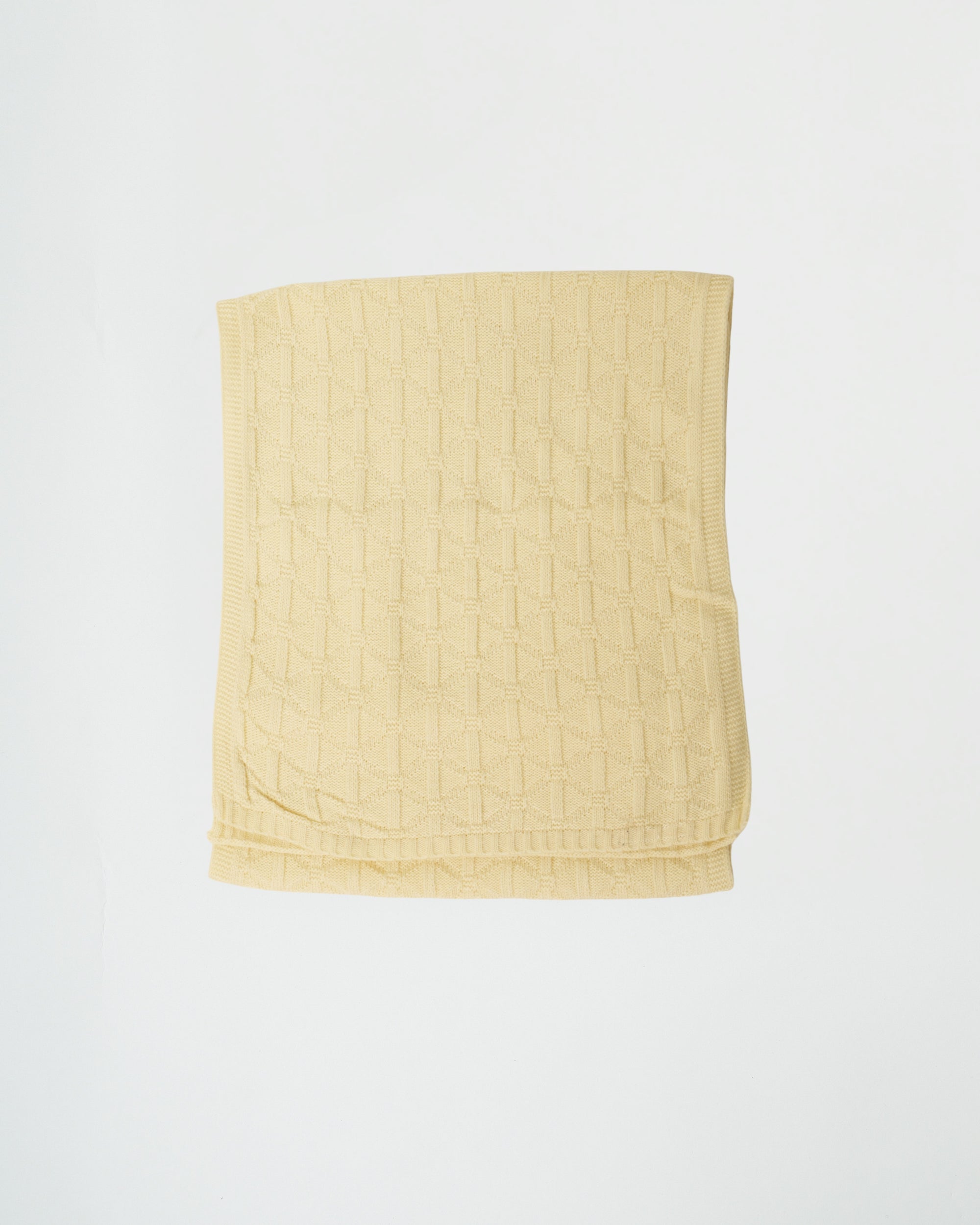 Yellow quilted blanket on a white background
