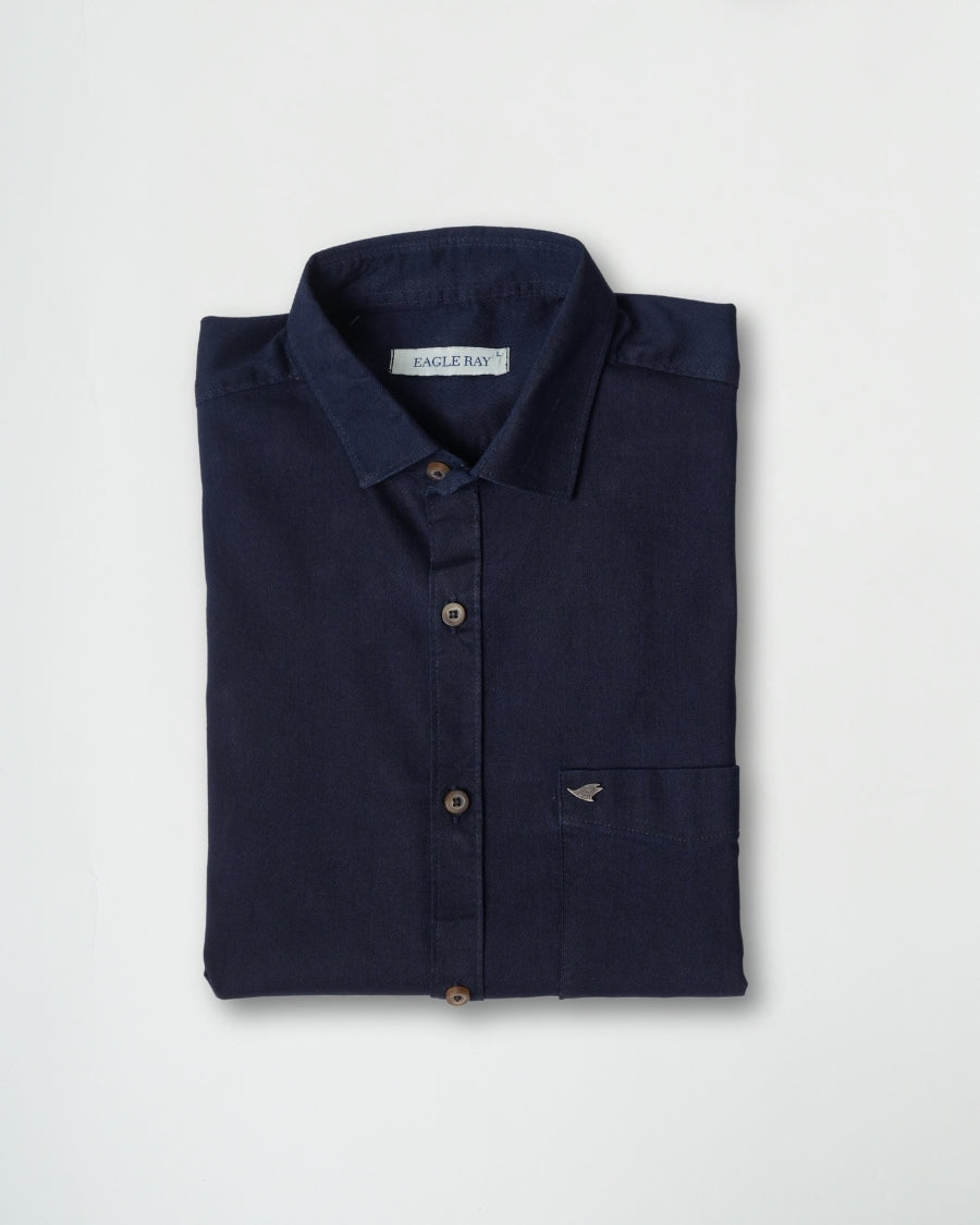 Folded navy shirt with brand label on a light gray background