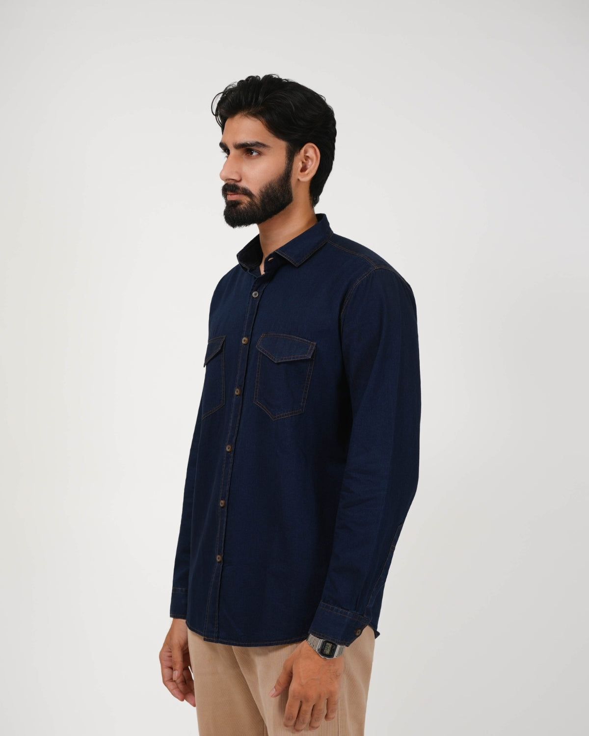 Man wearing a navy blue shirt against a white background