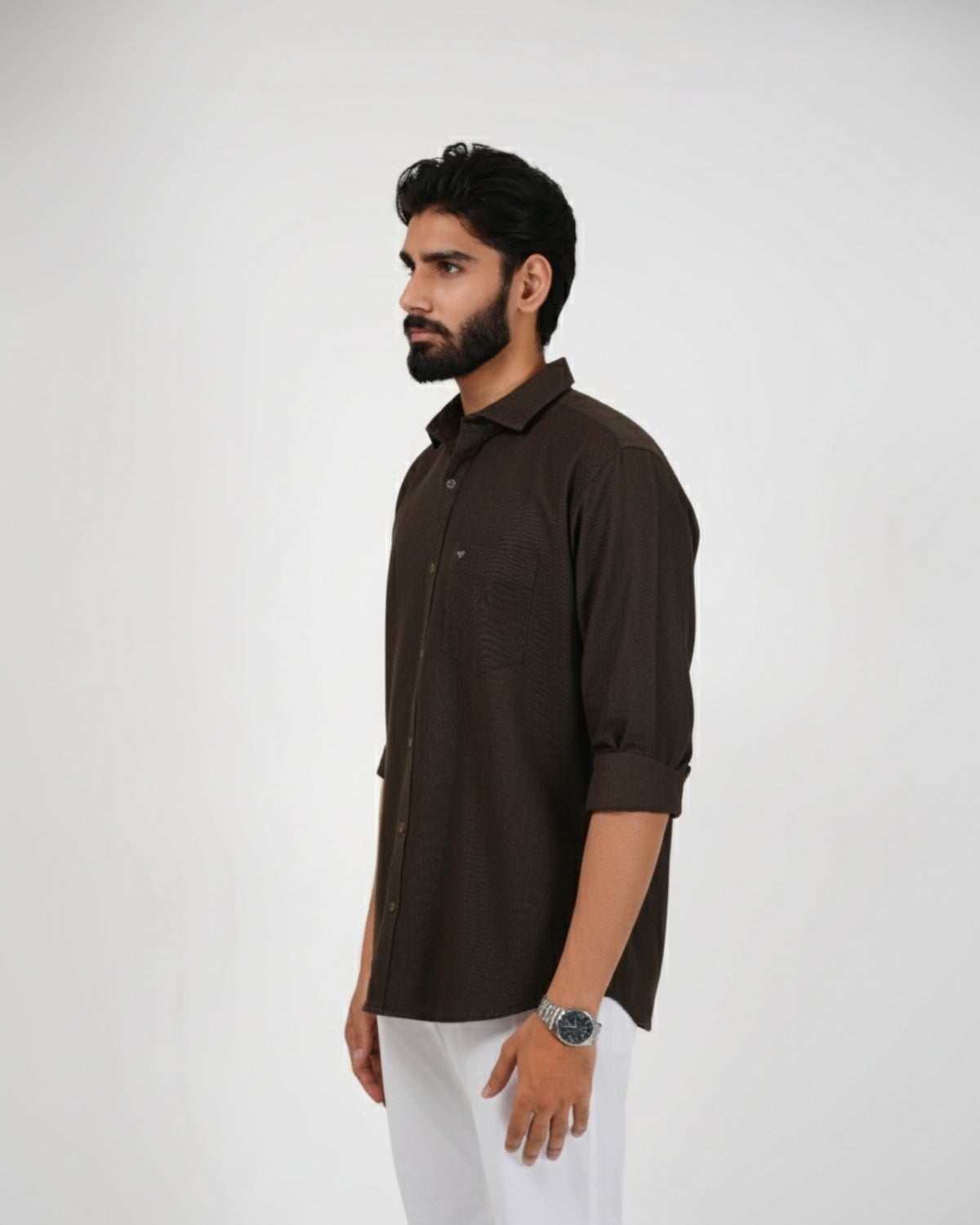 Man wearing a brown shirt and white pants on a white background