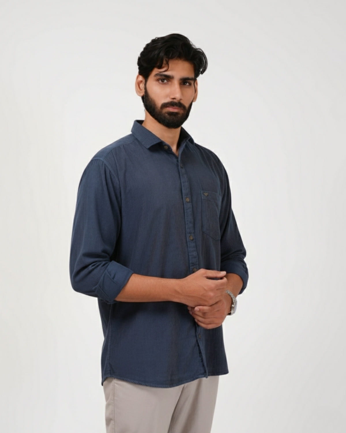Man wearing a dark blue shirt against a white background