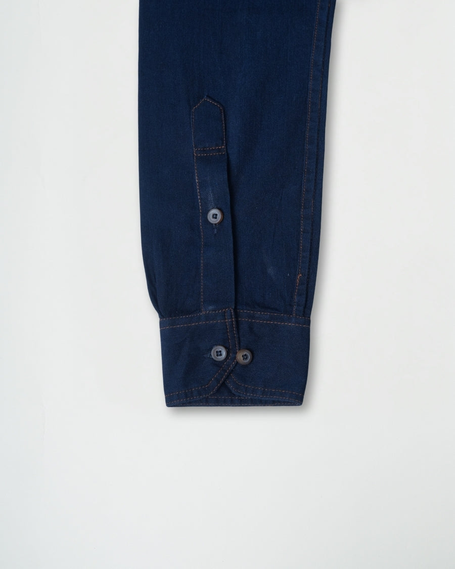Dark blue pants with buttons on a light gray background
