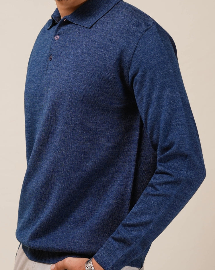Blue long-sleeve polo shirt worn by a person on a beige background