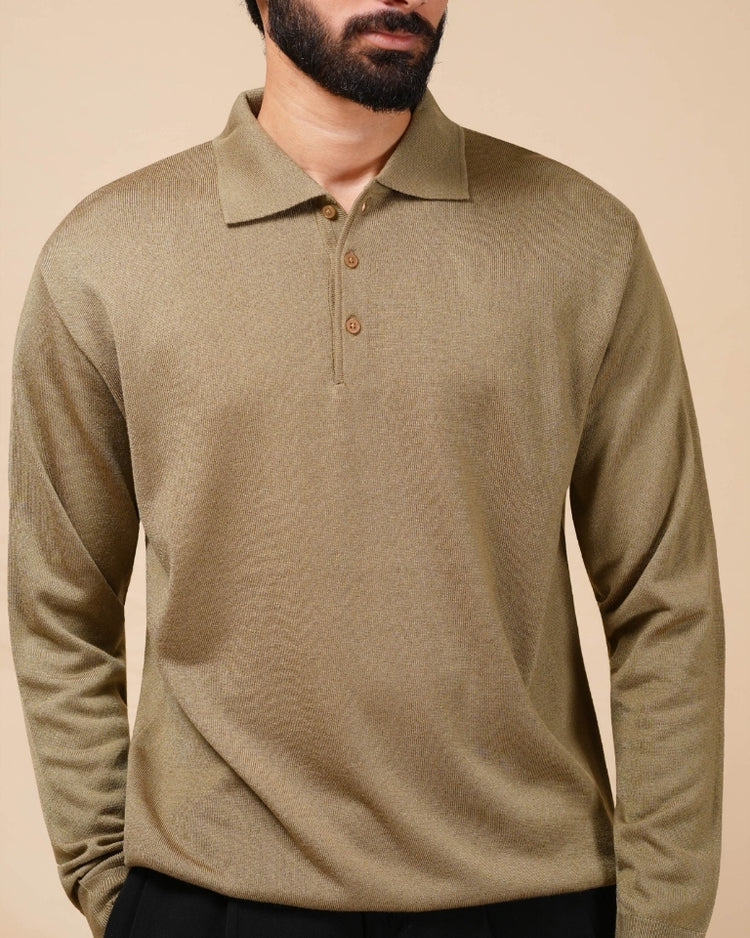 Man wearing a beige long-sleeve polo shirt against a beige background
