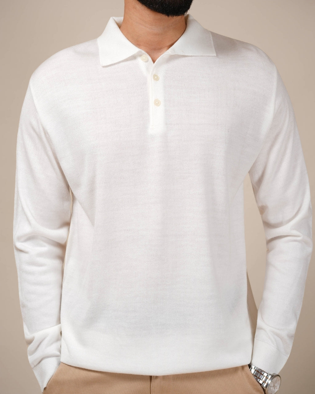 White long-sleeve polo shirt worn by a person on a beige background