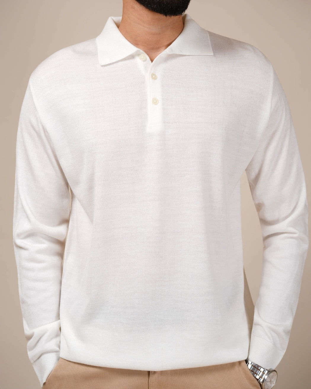 White long-sleeve polo shirt worn by a person on a beige background