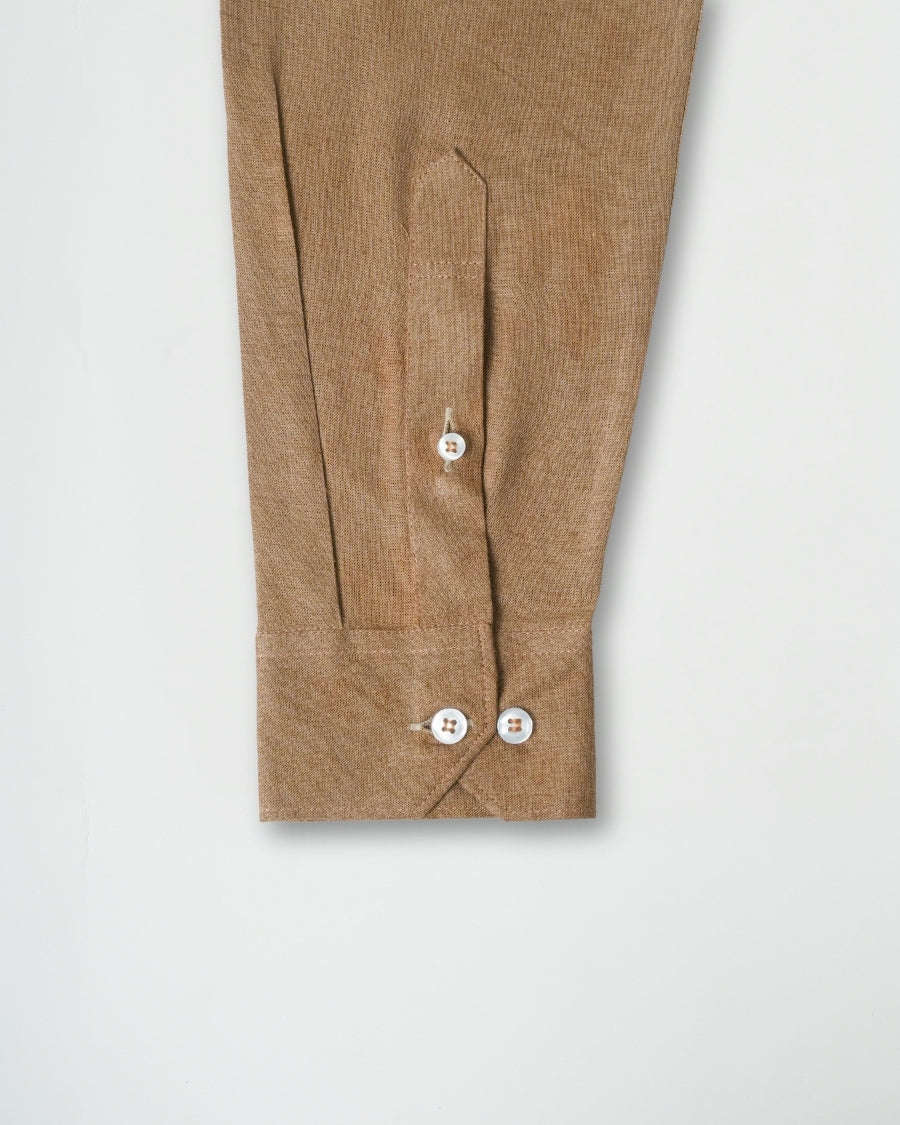 Brown pants with button details on a light gray background