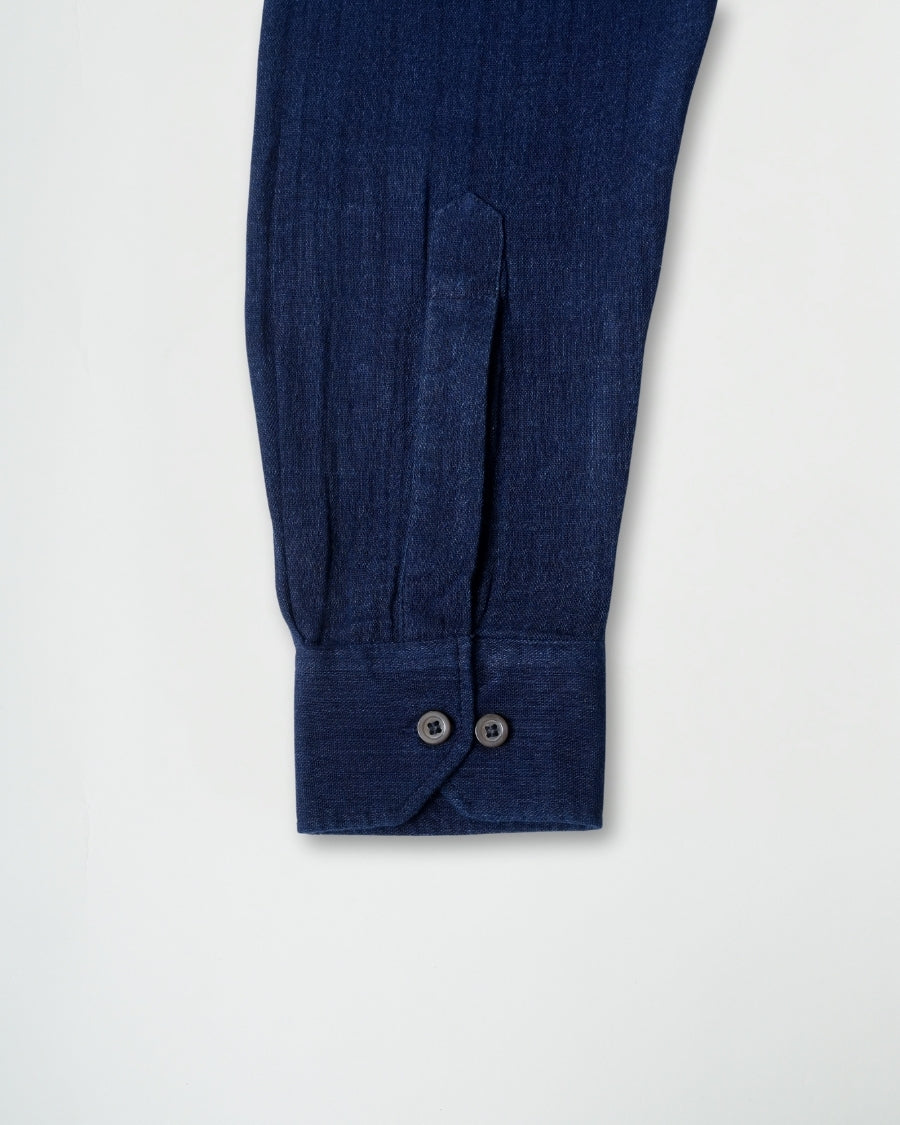 Close-up of a blue garment with buttons on a white background
