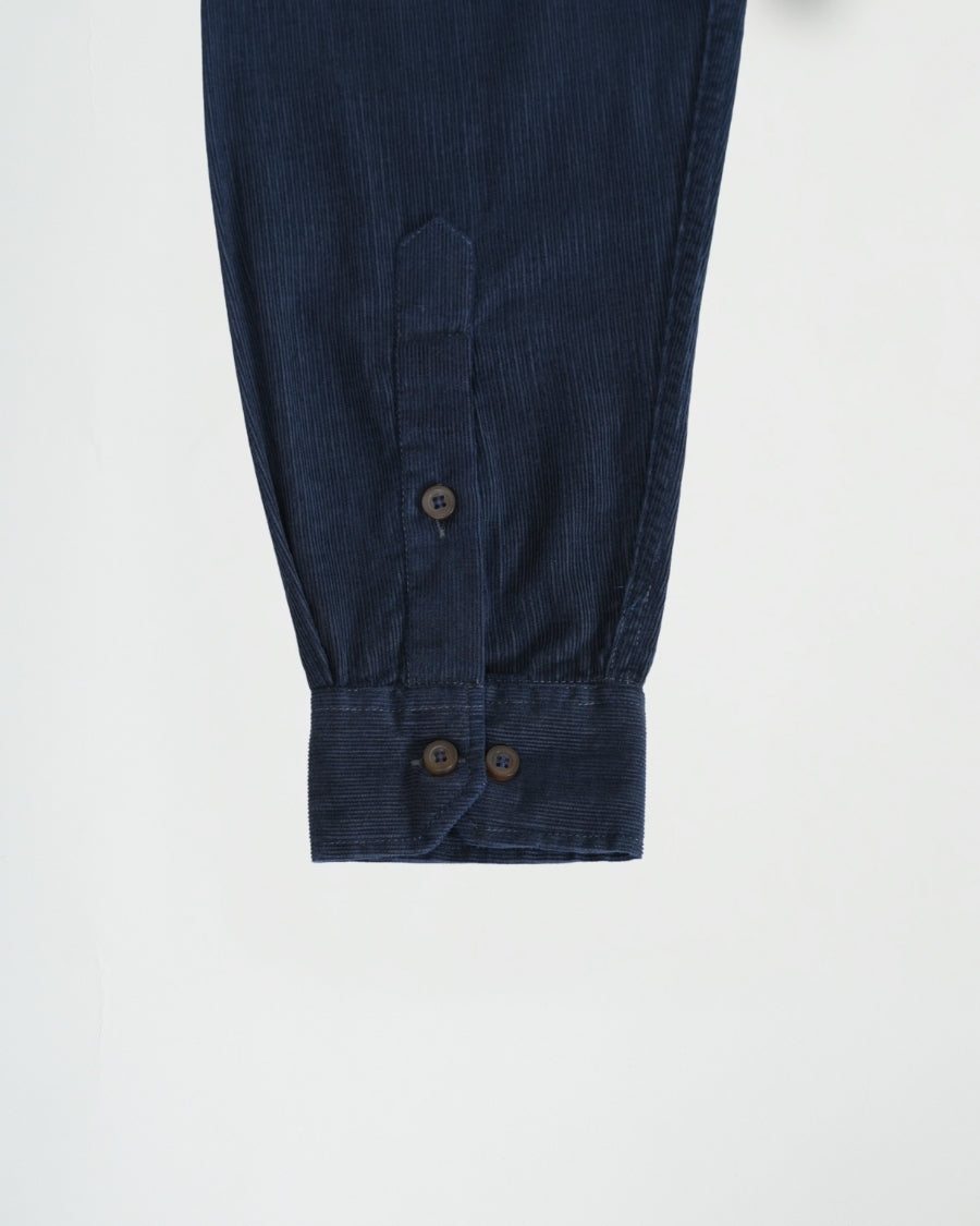 Close-up of dark blue pants with buttons on a white background