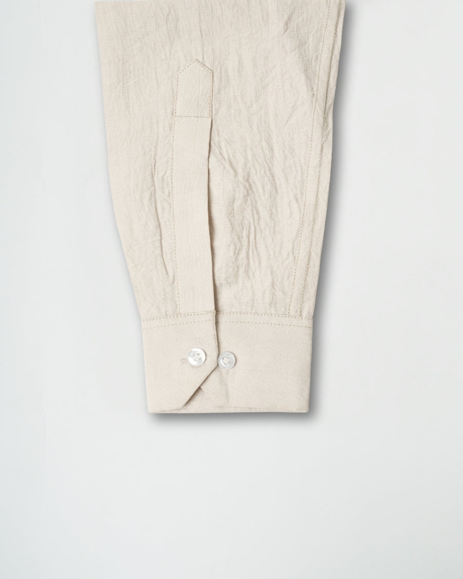 Beige pants with a button detail on a light gray background
